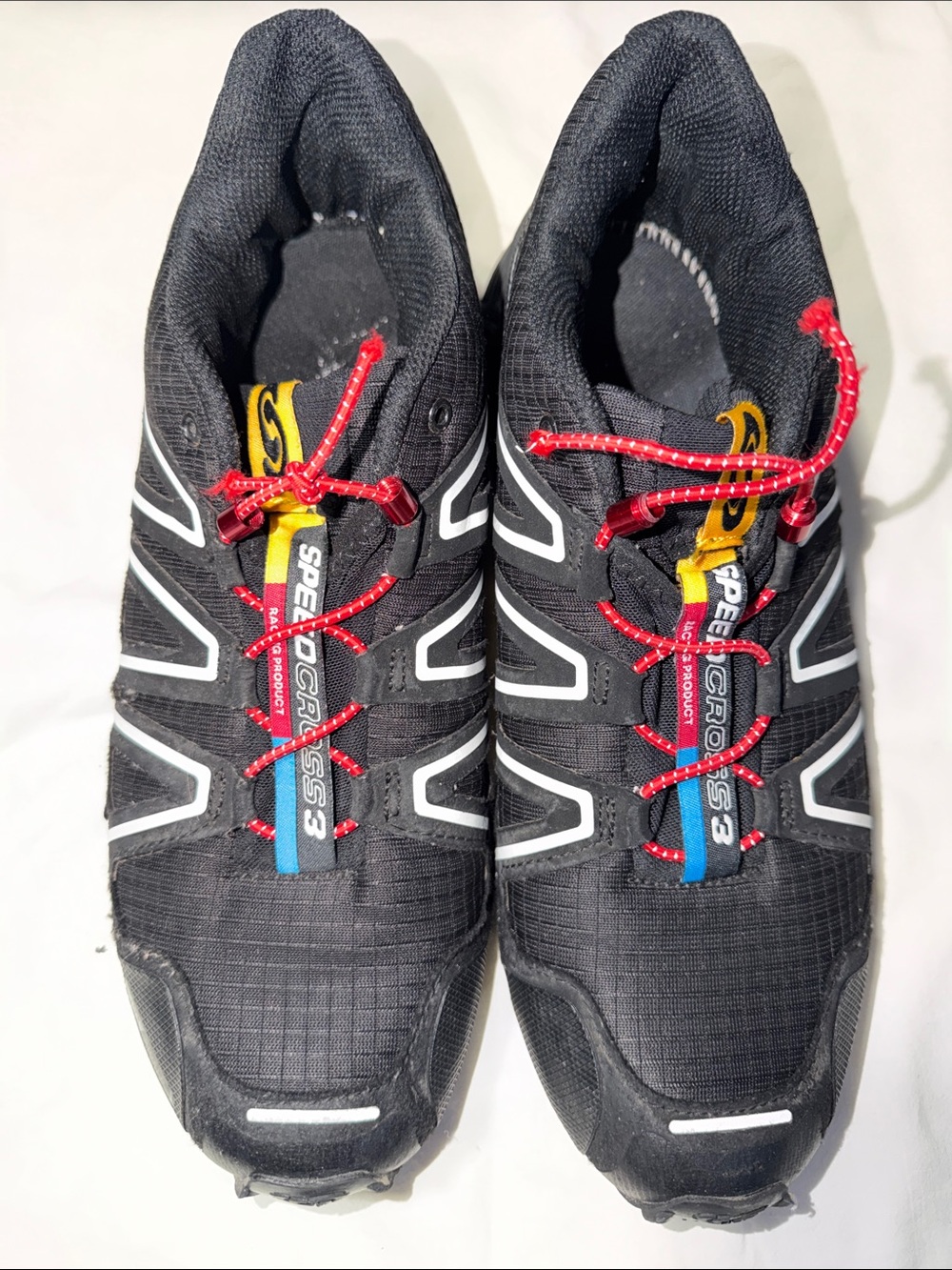 Salomon Black Trail Running Shoes with Red and Yellow Accents